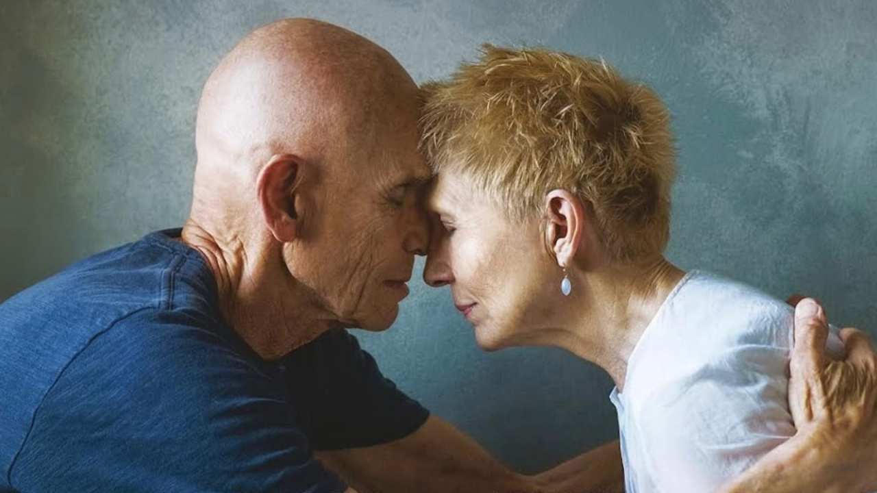 a man and woman with their faces pressed together